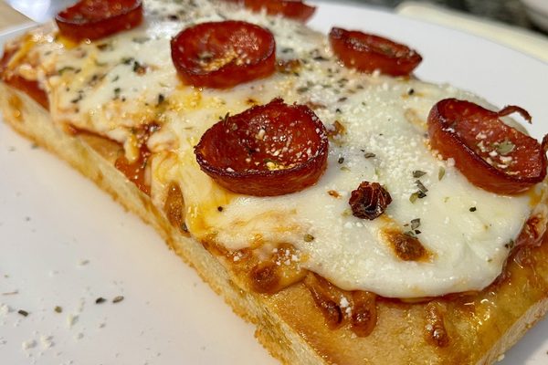 Square Sicilian pizza with melted mozzarella and crisp cupped pepperoni