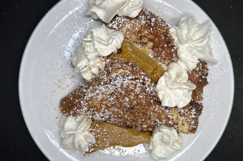 French toast with whipped cream and powdered sugar